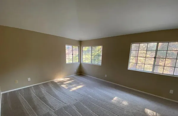 a view of an empty room with a window
