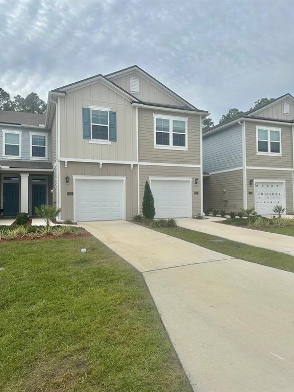 455 Redbud Road Palm Coast, FL 32137 - Photo 12 of 12 a front view of a house with a garden
