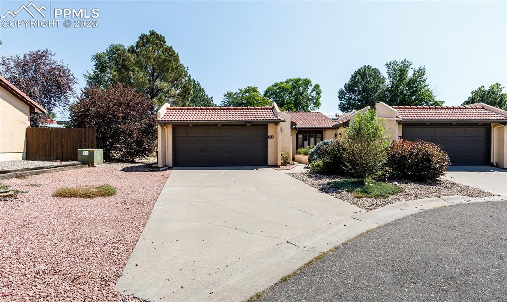 55 Bonnymede Road, Unit S Pueblo, CO 81001 - Photo 1 of 24 a front view of a house with a yard and garage