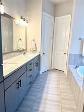 1315 West 24th Street, Unit B Houston, TX 77008 - Photo 15 of 26 a bathroom with a granite countertop sink and a mirror
