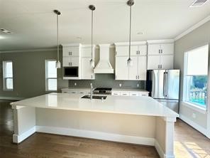1315 West 24th Street, Unit B Houston, TX 77008 - Photo 6 of 26 a kitchen with kitchen island a counter top space appliances and a counter top space