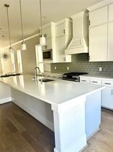 1315 West 24th Street, Unit B Houston, TX 77008 - Photo 8 of 26 a kitchen with kitchen island granite countertop a sink a stove and cabinets