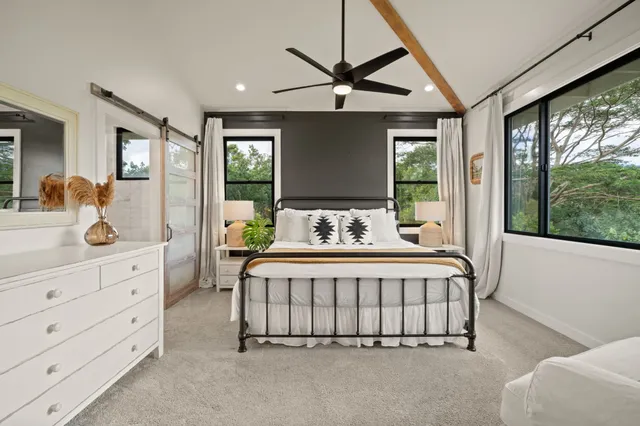 a bedroom with a large bed and a window