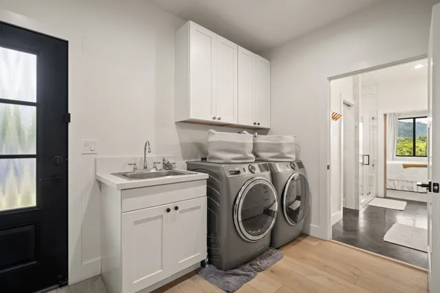 a utility room with sink dryer and washer