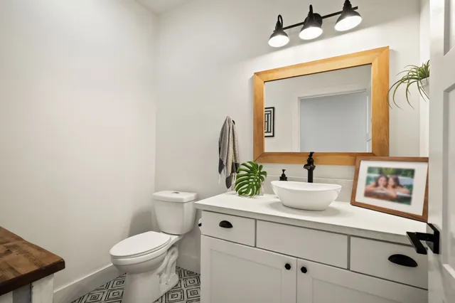 a bathroom with a toilet sink and mirror