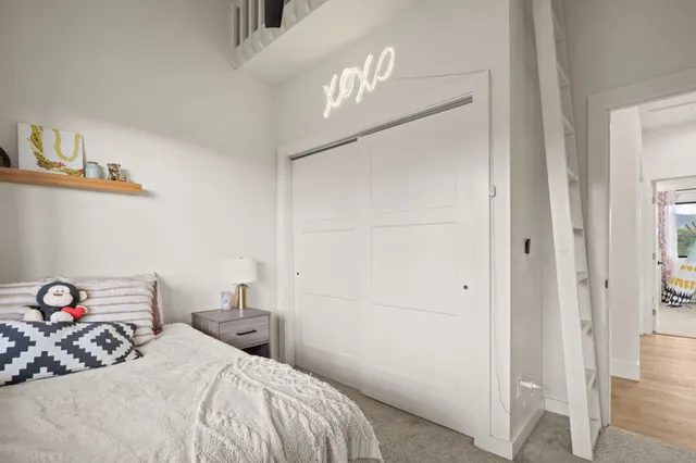 a bedroom with a bed and a chandelier