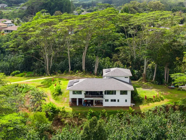 a view of a house with a backyard