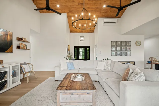a living room with furniture a large window and a flat screen tv