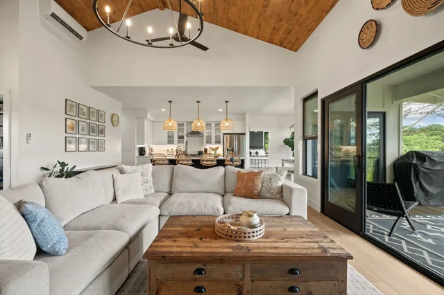 a living room with furniture and view of kitchen