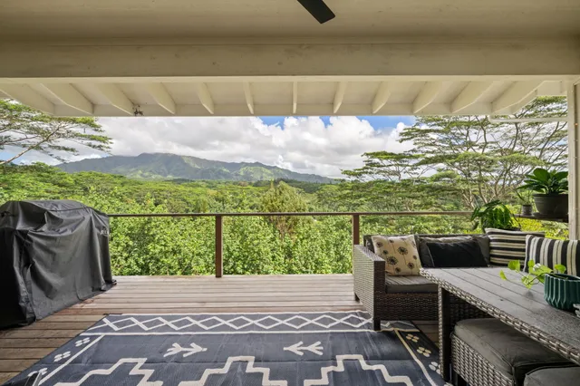 a view of a balcony with furniture and city view