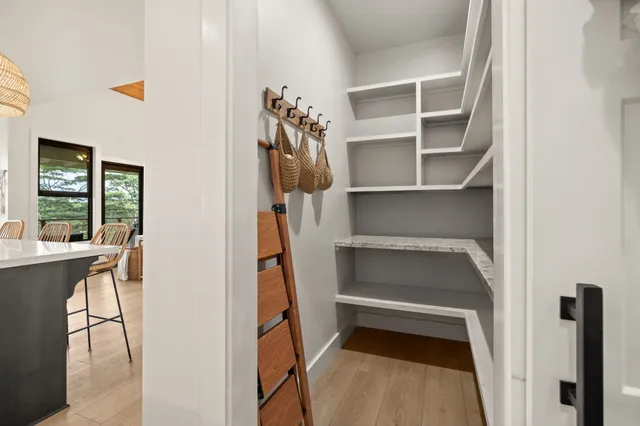 a view of walk in closet with clothes and shoes