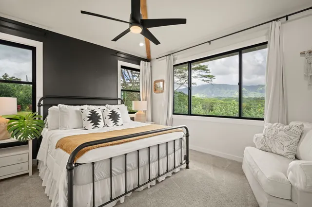 a bedroom with bed and a large window