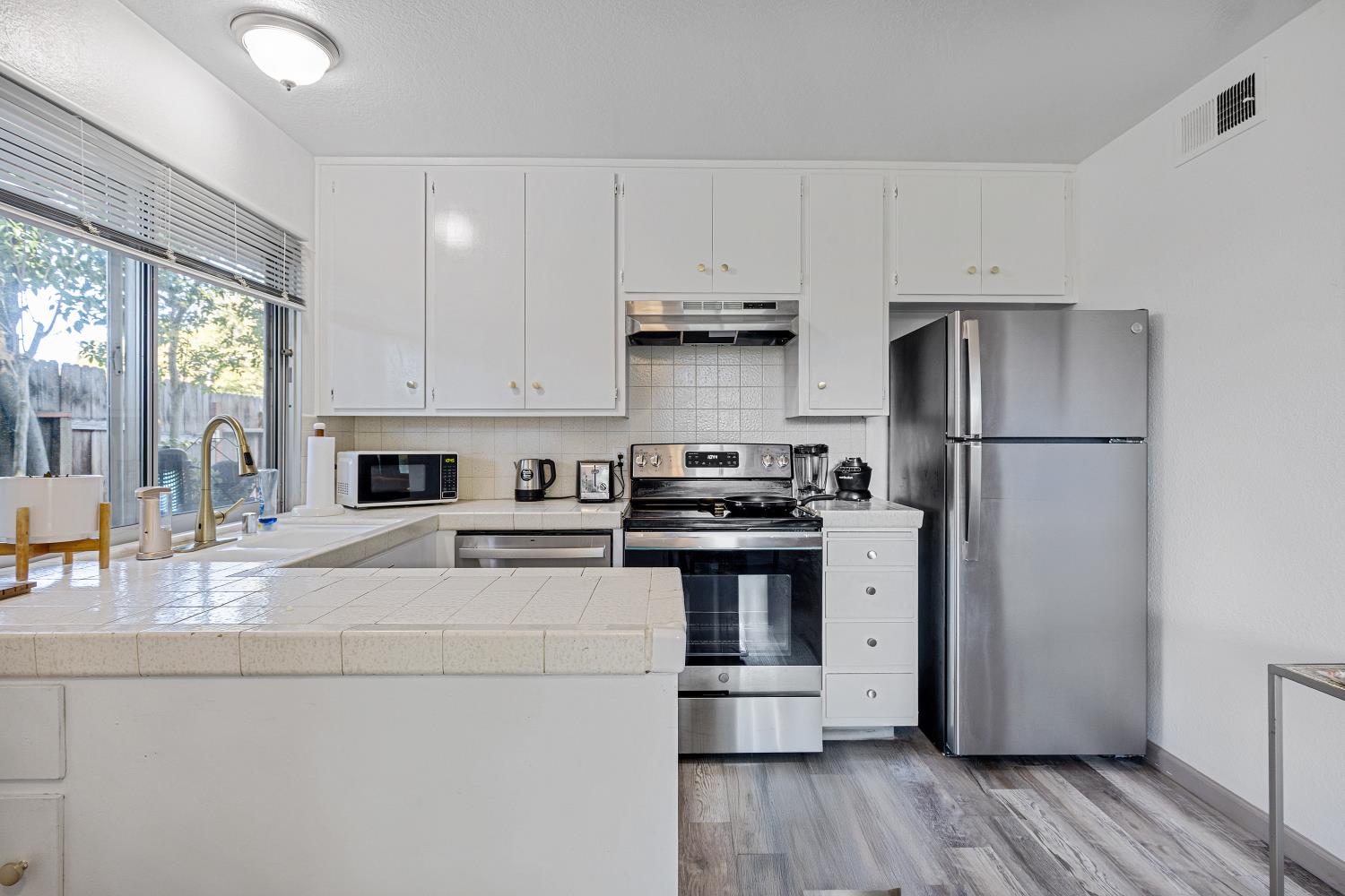 6415 Plymouth Road Stockton, CA 95207 - Photo 13 of 29 a kitchen with stainless steel appliances a refrigerator sink and stove