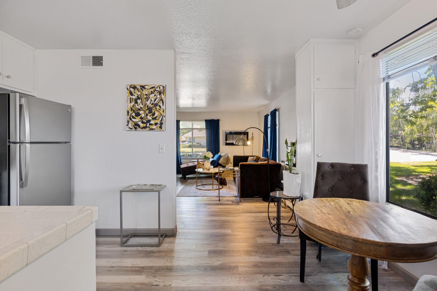 6415 Plymouth Road Stockton, CA 95207 - Photo 15 of 29 a living room with furniture a table and wooden floor