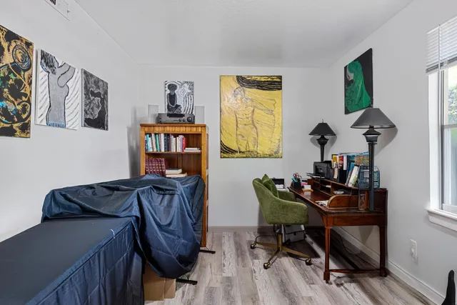 a view of a workspace with furniture and a window
