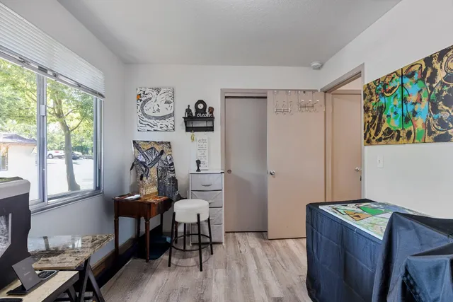 a view of a workspace with furniture and a window