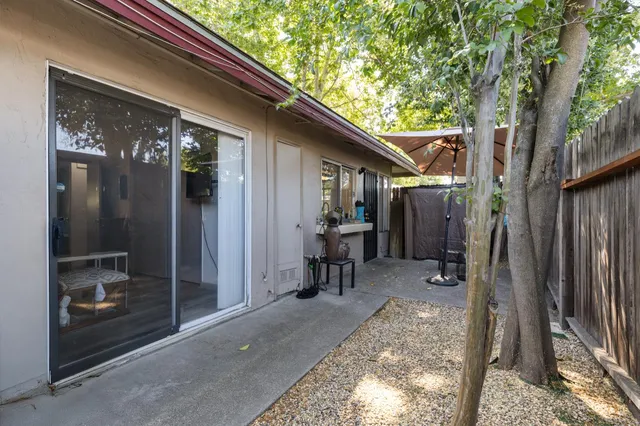 a backyard of a house with table and chairs