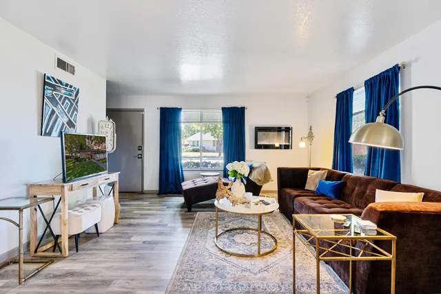 a living room with furniture and wooden floor