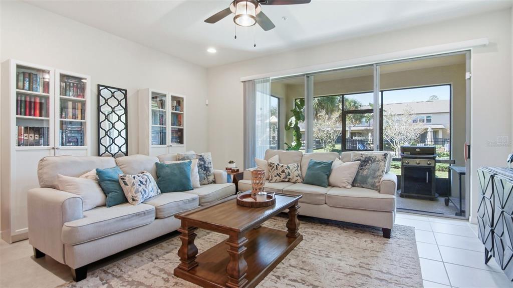 3013 Alessa Loop Apopka, FL 32703 - Photo 12 of 31 a living room with furniture and large windows