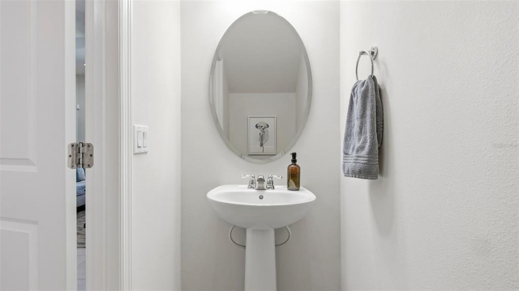 3013 Alessa Loop Apopka, FL 32703 - Photo 16 of 31 a bathroom with a sink and a mirror