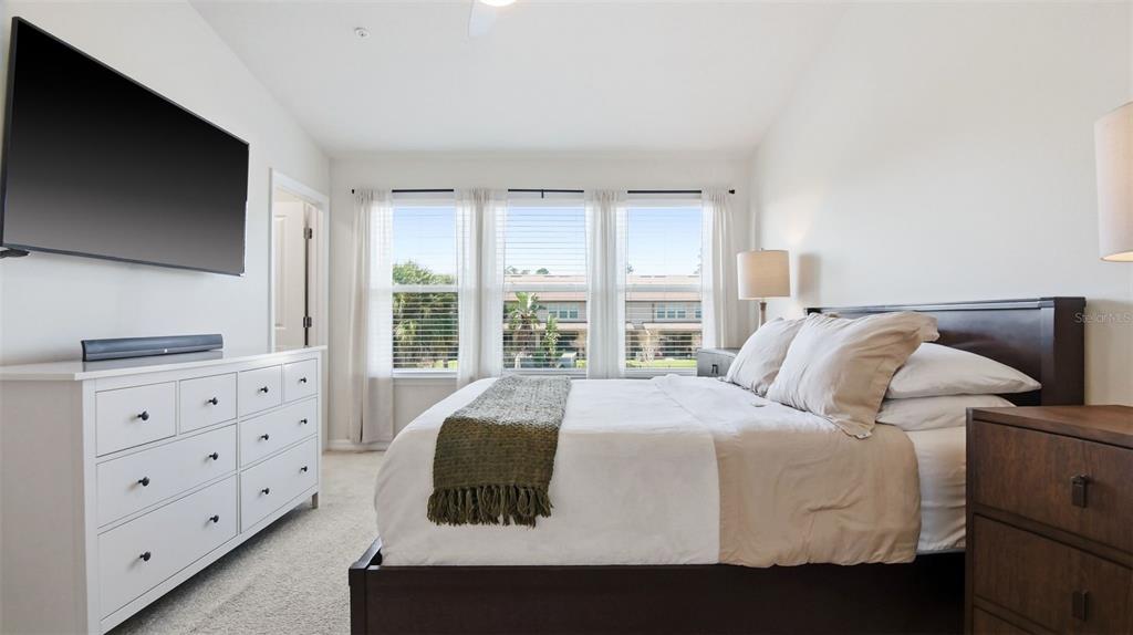 3013 Alessa Loop Apopka, FL 32703 - Photo 17 of 31 a bedroom with a bed and a flat screen tv