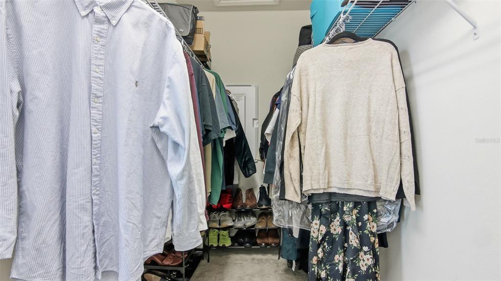 3013 Alessa Loop Apopka, FL 32703 - Photo 21 of 31 a view of walk in closet with clothes