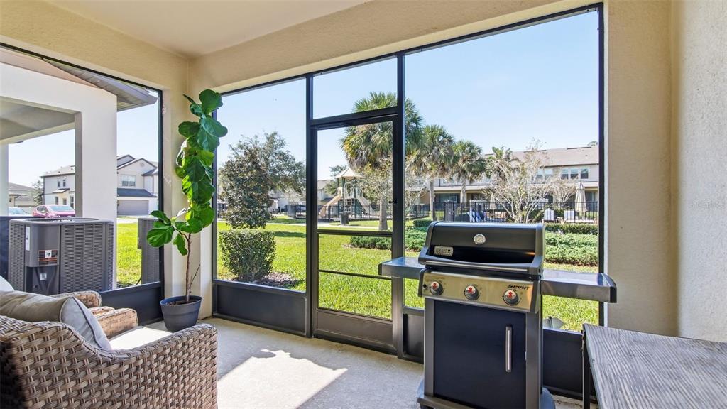 3013 Alessa Loop Apopka, FL 32703 - Photo 26 of 31 a living room with furniture tv and a floor to ceiling window