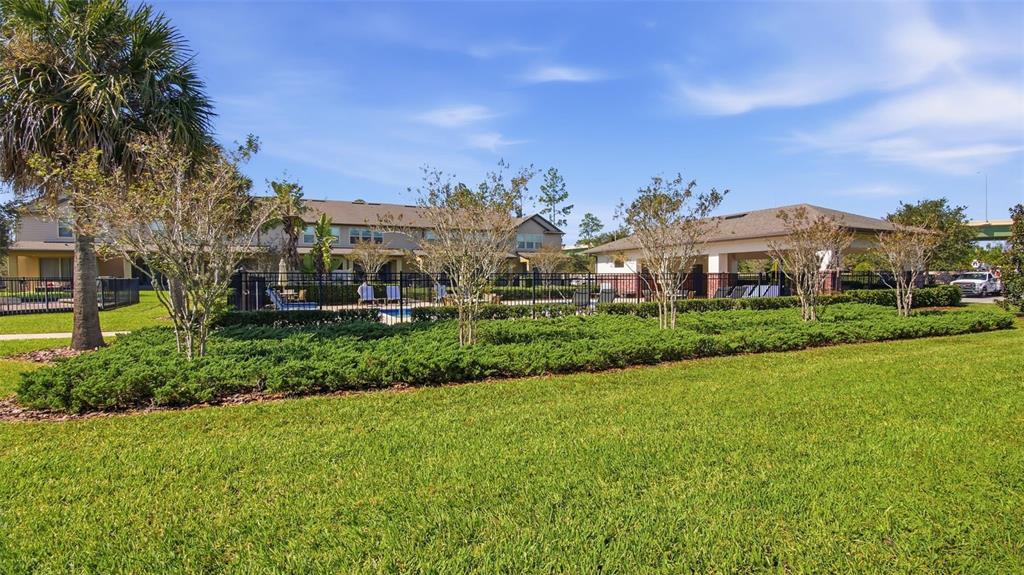 3013 Alessa Loop Apopka, FL 32703 - Photo 30 of 31 a view of a big house with a big yard and large trees