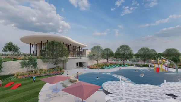 a view of a building with a big yard and a large trees