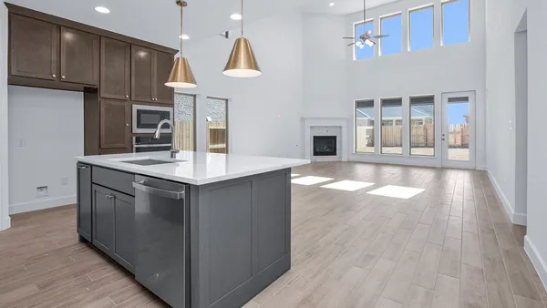 a kitchen with kitchen island granite countertop a stove and a wooden floors