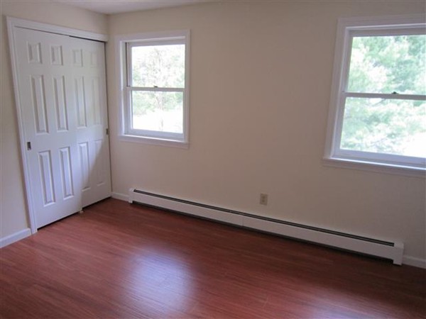 57 North Plain Road Sunderland, MA 01375 - Photo 11 of 13 an empty room with wooden floor and windows
