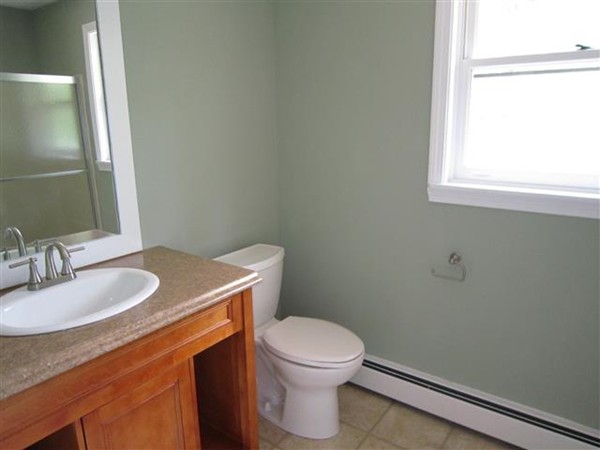 57 North Plain Road Sunderland, MA 01375 - Photo 9 of 13 a bathroom with a granite countertop toilet a sink and a mirror