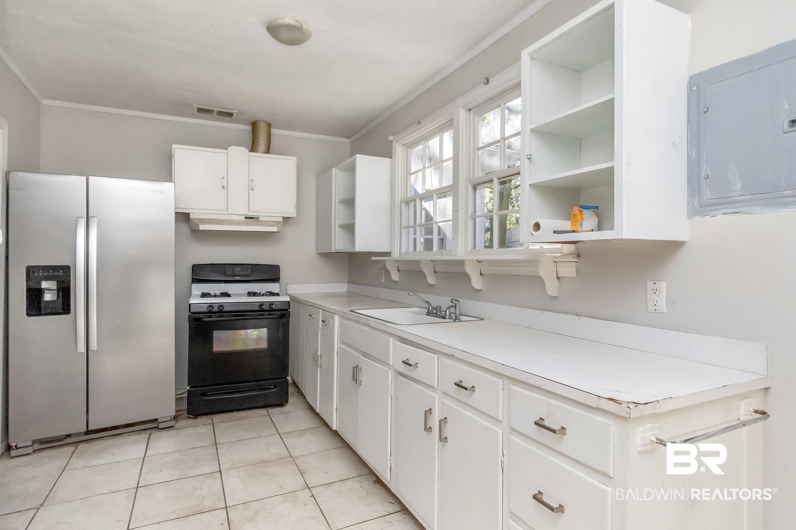 5001 Hillwood Circle South Mobile, AL 36608 - Photo 10 of 20 Kitchen with a sink, stainless steel refrigerator with ice dispenser, electric panel, open shelves, and gas stove