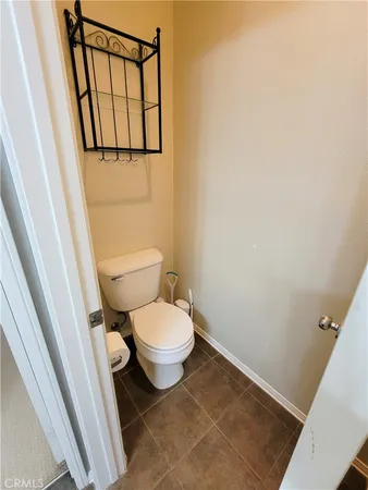 a white toilet sitting next to a small sink