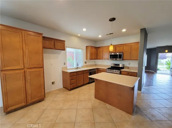 a kitchen with stainless steel appliances granite countertop a refrigerator sink and cabinets