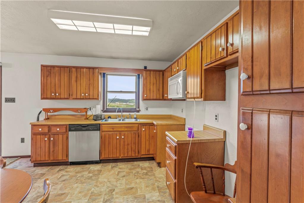851 Mounts Road Washington, PA 15301 - Photo 11 of 28 a kitchen with stainless steel appliances granite countertop a sink stove and cabinets