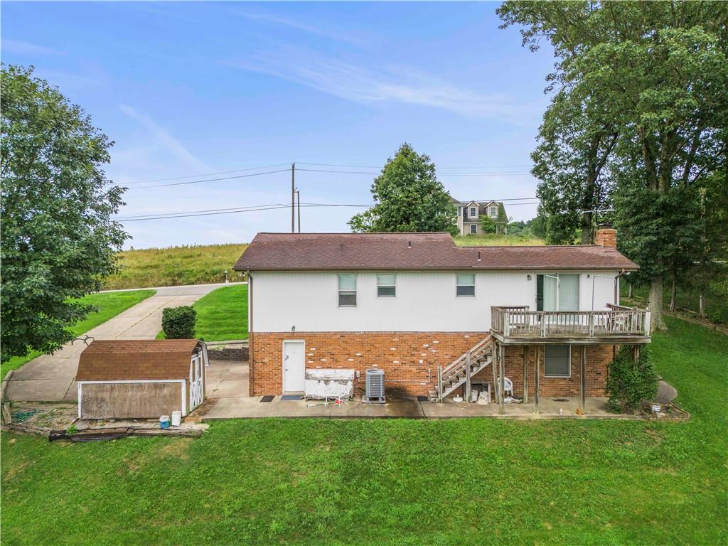 851 Mounts Road Washington, PA 15301 - Photo 24 of 28 a front view of a house with a garden and a tree