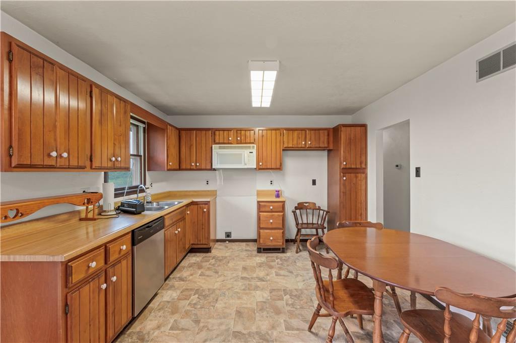 851 Mounts Road Washington, PA 15301 - Photo 10 of 28 a kitchen with stainless steel appliances granite countertop a sink a stove counter space and cabinets