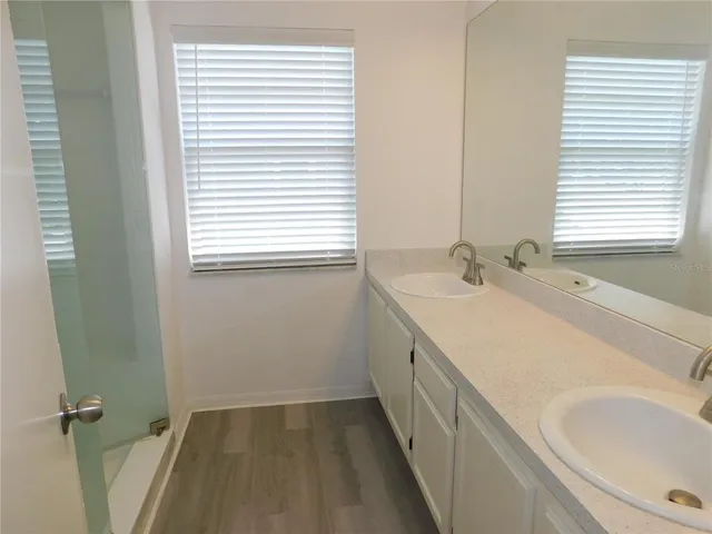 a bathroom with a granite countertop shower