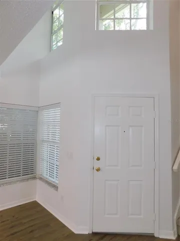 a view of a livingroom with wooden floor and window