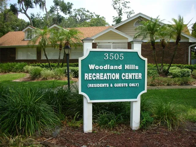 a view of a swimming pool with outdoor seating and plants