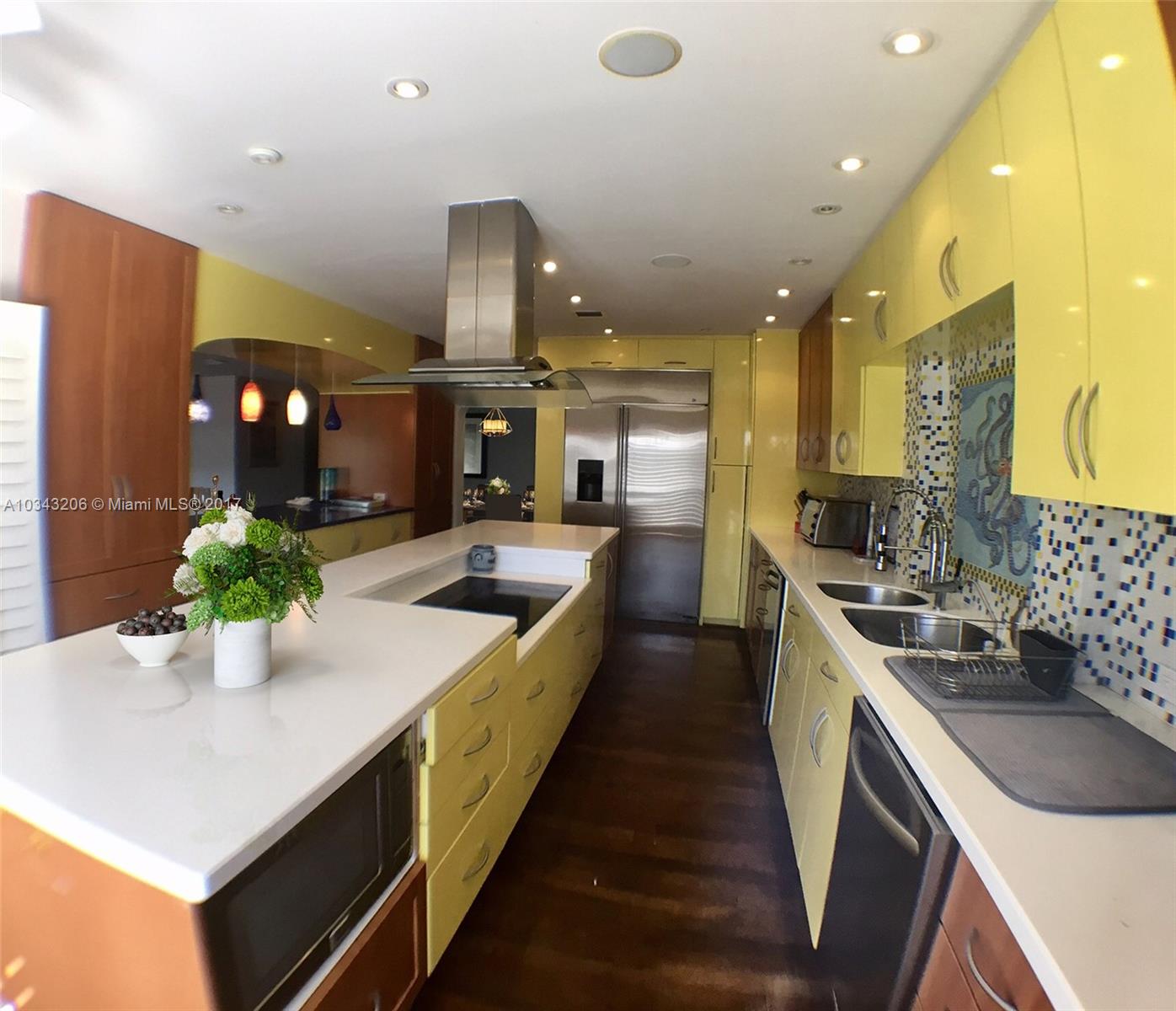 608 Boca Marina Court, Unit 608 Boca Raton, FL 33487 - Photo 5 of 20 OPEN KITCHEN WITH COOKING ISLAND AND CORIAN COUNTER TOPS