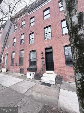 a view of a brick building with many windows