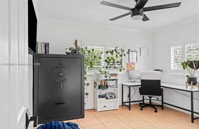 a view of a workspace with furniture and a window