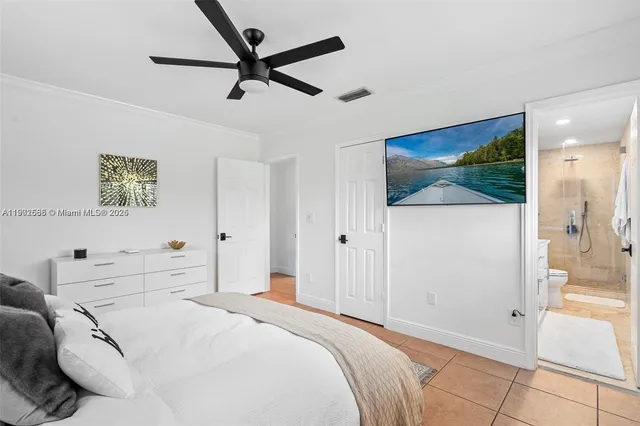 a bedroom with a bed and a painting on the wall