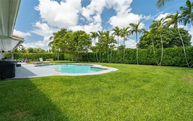 a view of a swimming pool and a yard