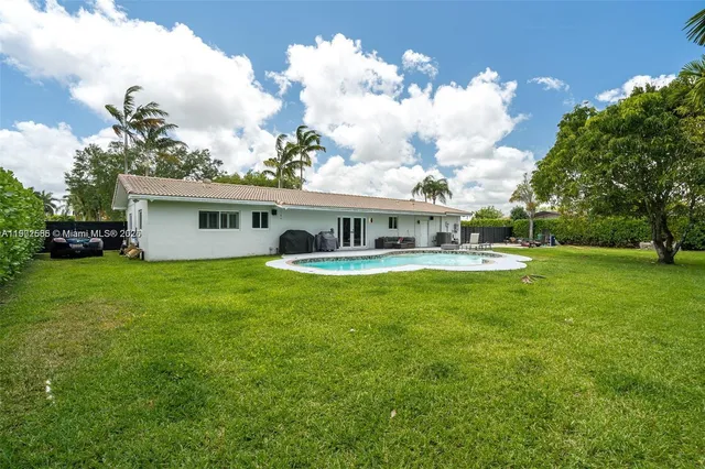 a front view of house with yard and green space