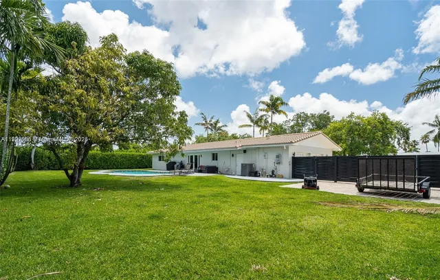 a view of a house with a yard and sitting area