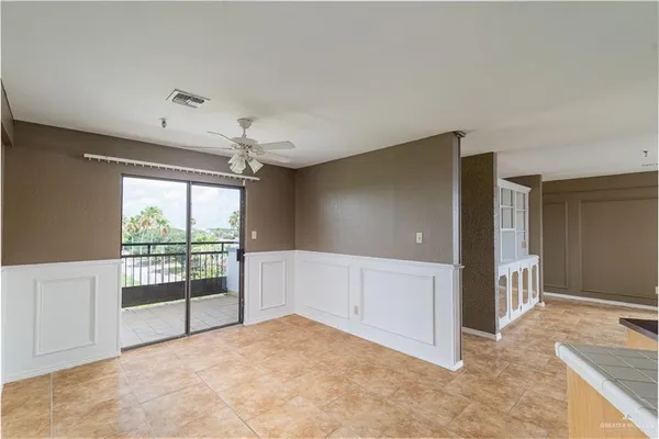 an empty room with windows and chandelier