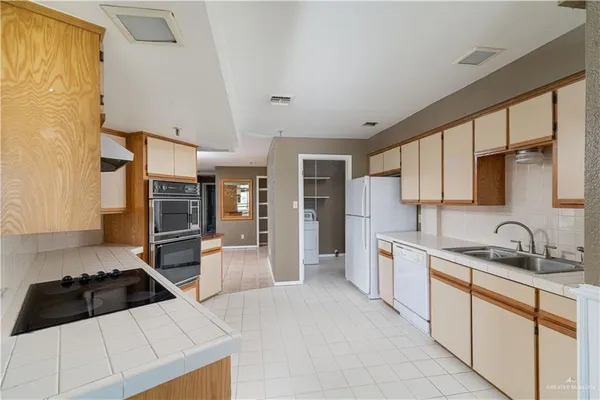 a kitchen with stainless steel appliances a sink stove and refrigerator